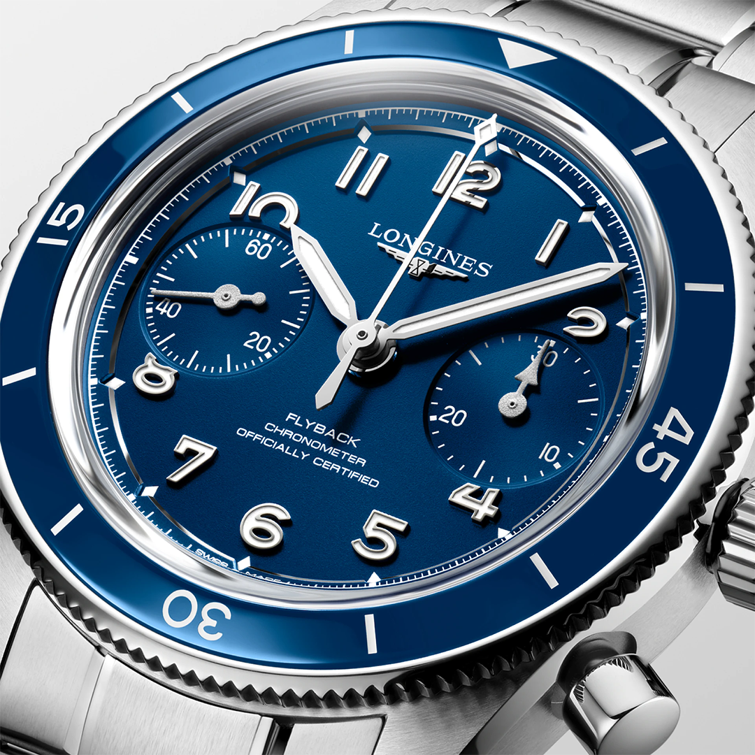 Blue Longines Spirit Pilot Flyback Automatic Manual Winding 39.5mm Watch with a rotating bezel, two sub-dials, and Arabic numeral hour markers on a stainless steel bracelet.