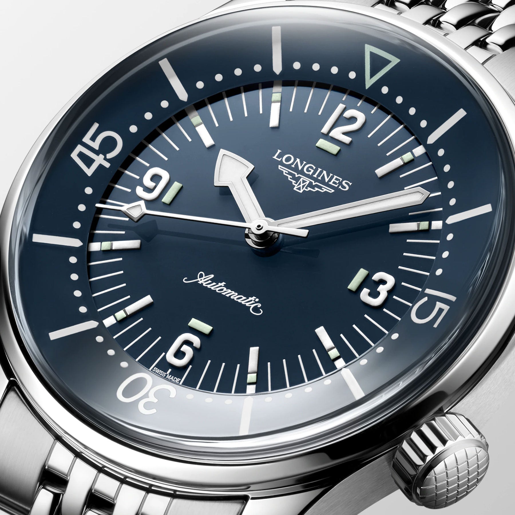 Close-up of a Longines Legend Diver Automatic 39mm Watch, displaying a silver metal band and a dark blue dial. The timepiece features prominent white numerals and markers with the 'Automatic' label. Below the 12 o'clock position is the Longines brand logo, and the bezel is intricately detailed with minute markings.