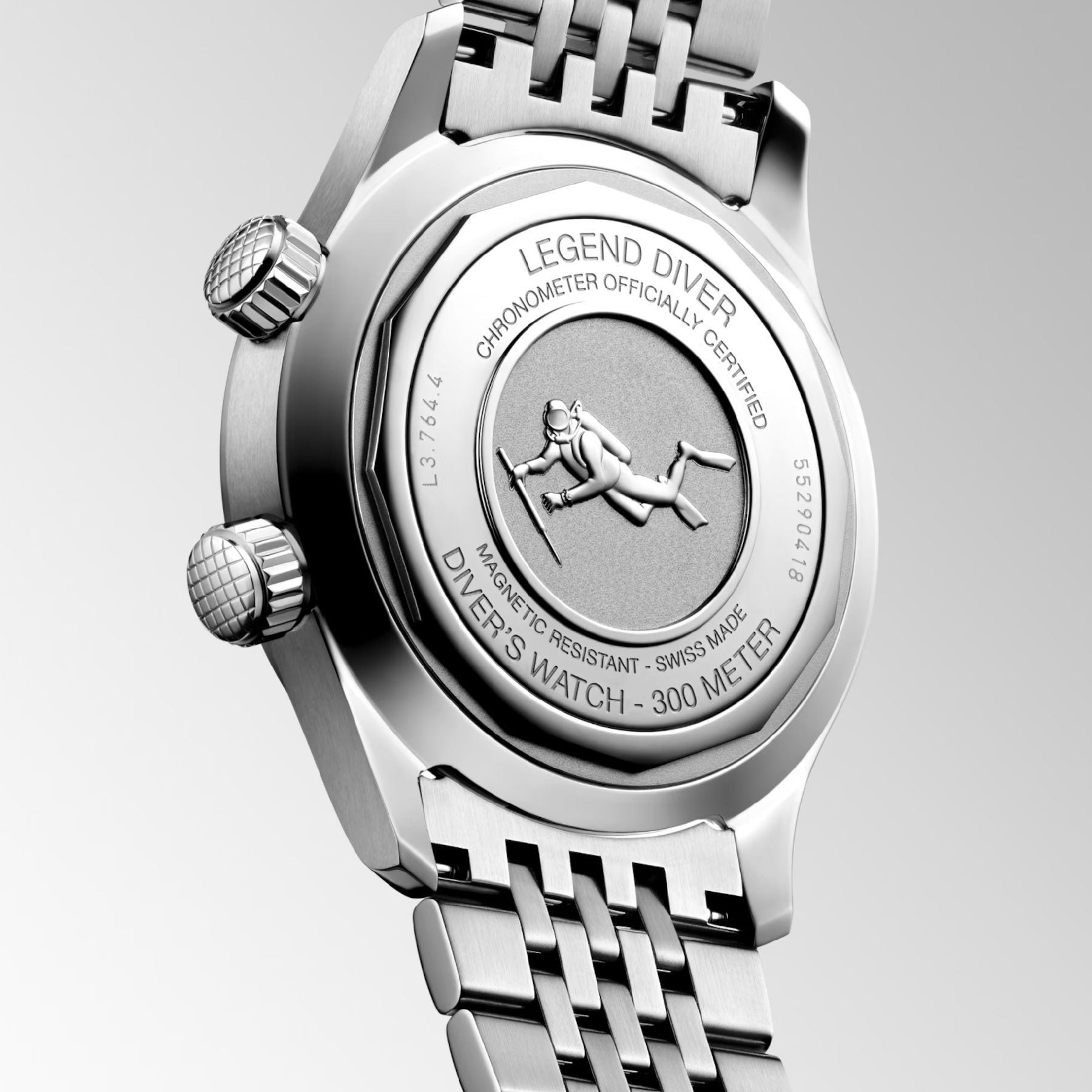 The image showcases the back of a Longines Legend Diver Automatic 39mm Watch, highlighting details such as "Legend Diver," "300 Meters," "Swiss Made," along with the LONGINES LEGEND DIVER emblem. This sophisticated and chronometer-certified timepiece comes with a metal bracelet and two crown knobs, making it perfect for any divers' watch enthusiast.