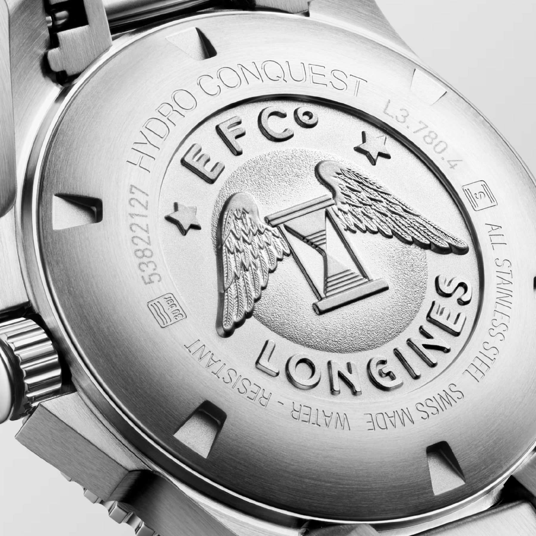 Detailed close-up of the back of a Longines Hydroconquest Automatic 39mm Watch, highlighting the embossed Longines logo featuring an hourglass and wings, surrounded by stars. The intricate details emphasize "EFC," "HydroConquest," "All Stainless Steel," and "Swiss Made Water Resistant.