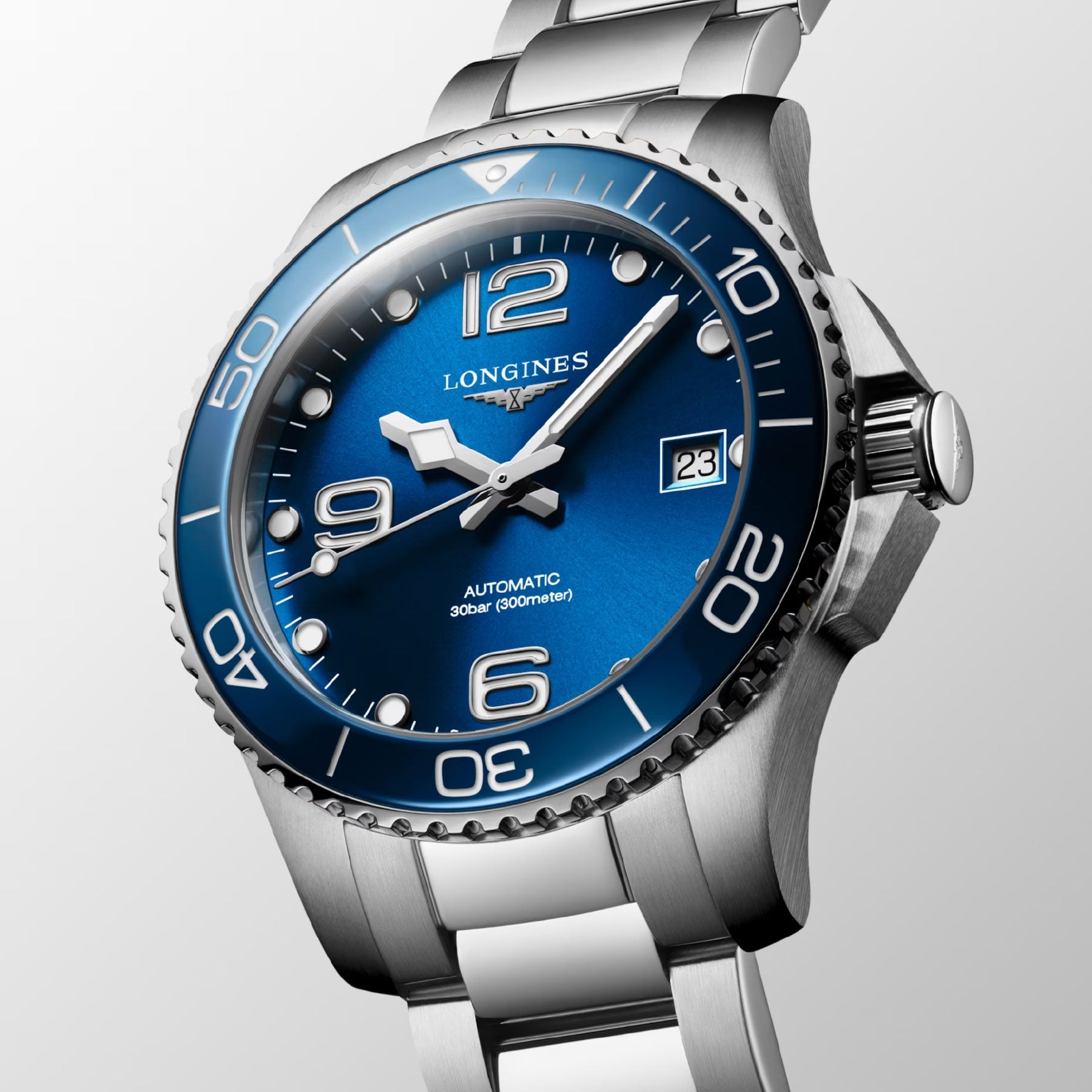 A detailed view of the Longines Hydroconquest Automatic 39mm Watch reveals its captivating blue dial, featuring white numerals and indices. This timepiece includes a date display and a rotating bezel marked at intervals. The luminous hands and markers underscore its automatic Swiss craftsmanship and water-resistant design from Longines.