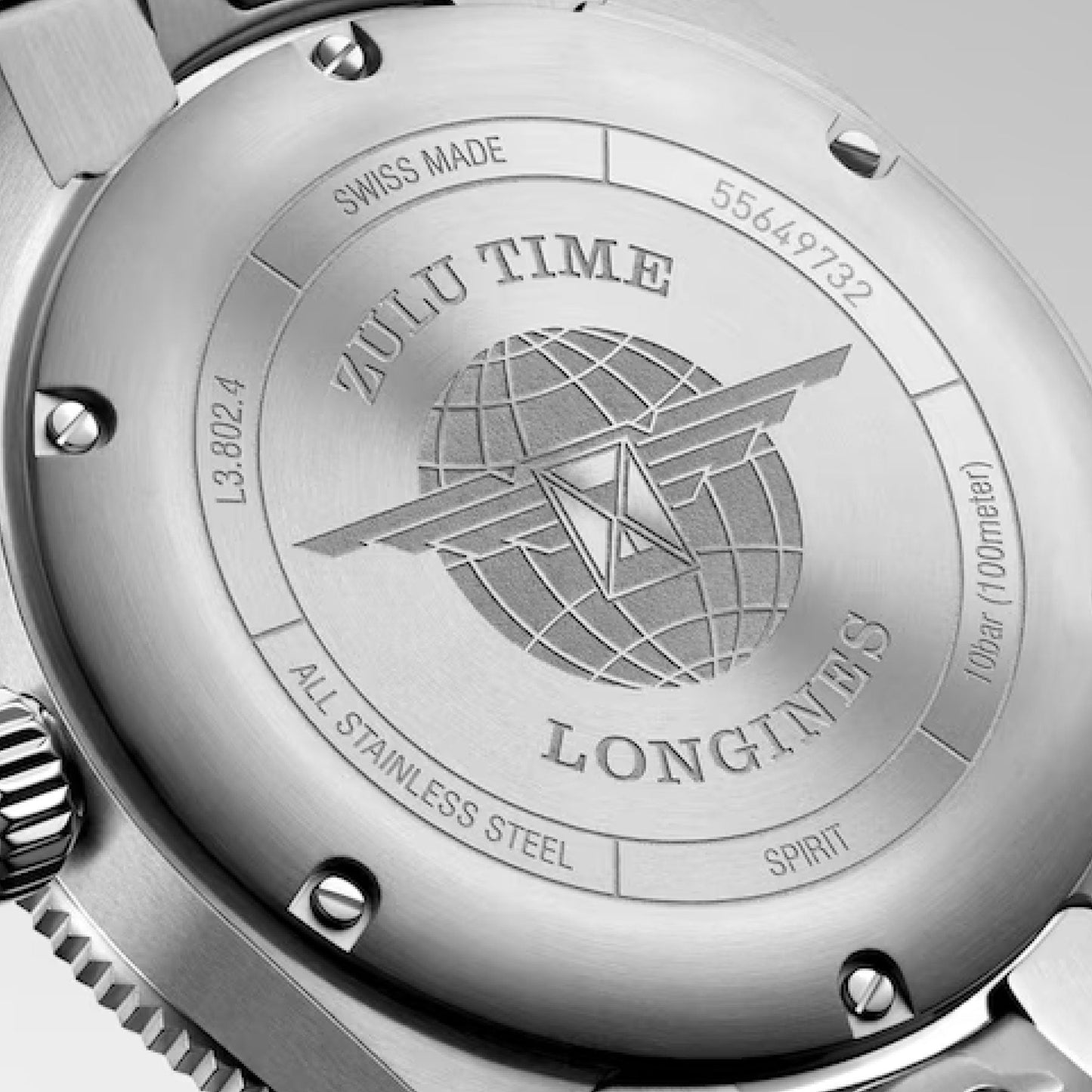 On the back of the Longines Spirit Zulu Time Automatic COSC 39mm Watch, you will find the engravings "Zulu Time" and "Spirit," along with "All Stainless Steel" and "Swiss Made." The design adds an adventurous flair with a globe bearing wings and several model numbers.