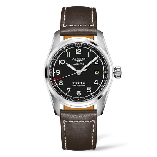 The Longines Spirit Automatic 40mm Watch by Longines features a brown leather strap and a black dial. It includes silver and red hands, Arabic numerals, a date window, and is encased in silver. Enhancing its classic appeal, the watch displays "Automatic" with five stars above "Chronometer.