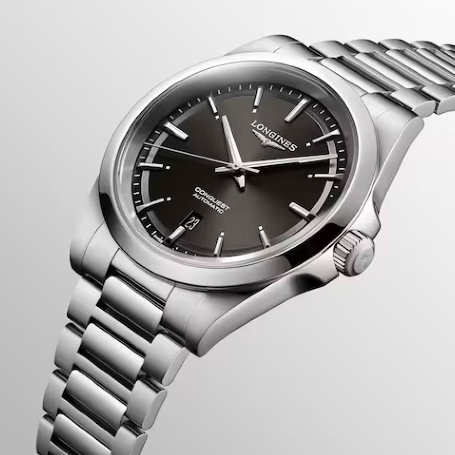 A Longines Conquest Automatic 41mm watch with a silver stainless steel case featuring a black dial and metal bracelet. The watch face prominently displays the brand name "Longines," complemented by silver hour markers and hands, along with a date window at the 3 o'clock position.