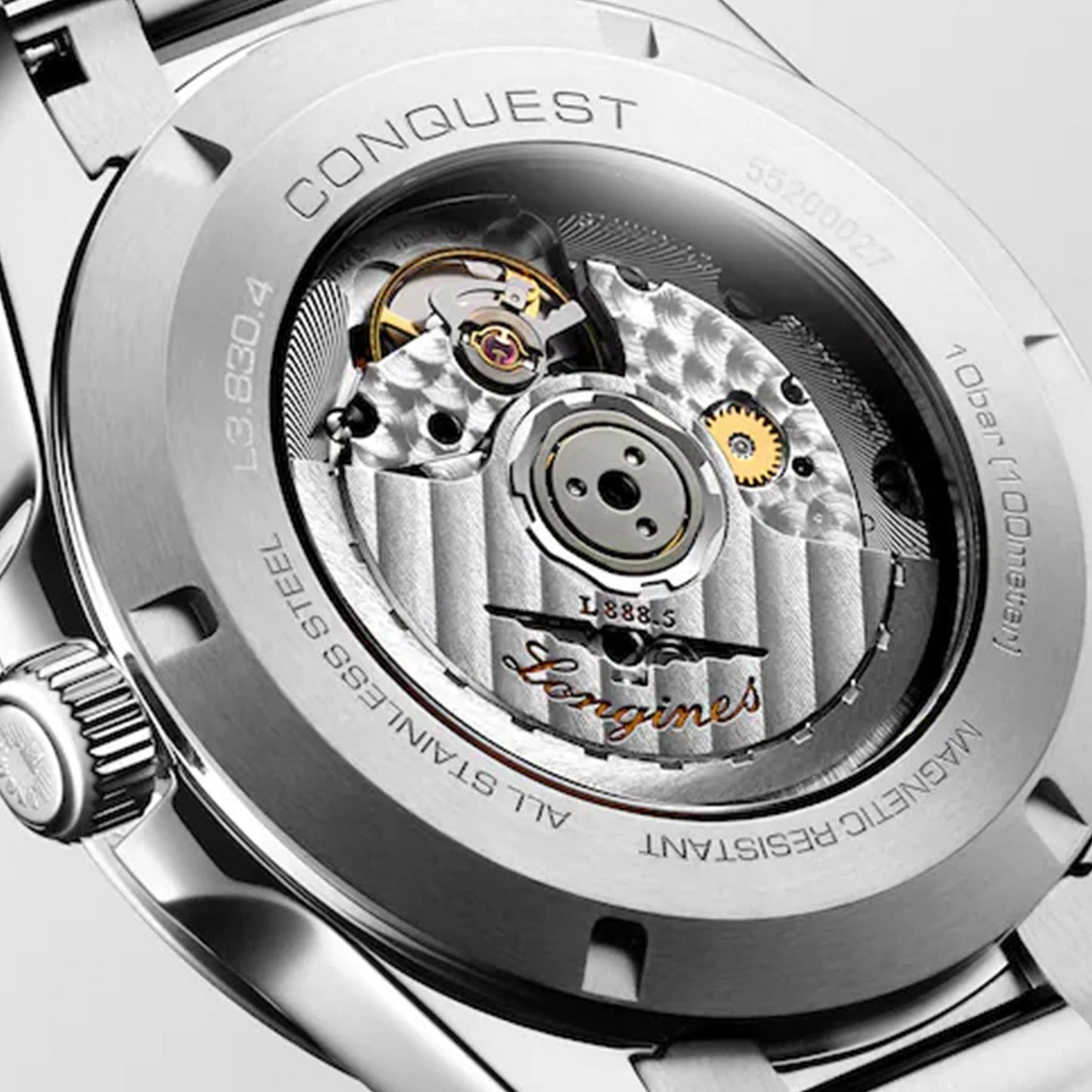 Close-up of the Longines Conquest Automatic 41mm Watch's stainless steel case back, revealing the intricate mechanical movement inside. The timepiece prominently features "Conquest," water resistance details, and the Longines brand markings, with visible gears and textures that exude craftsmanship.