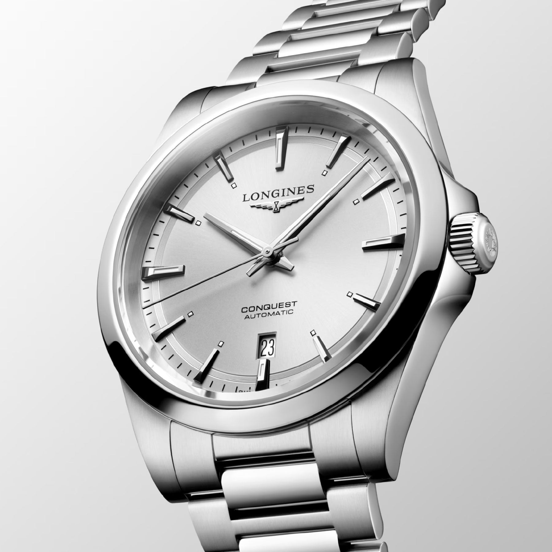 Introducing the Longines Conquest Automatic 41mm Watch—a silver stainless steel timepiece that epitomizes performance and elegance. Its sleek, polished aesthetics include a minimalist dial adorned with silver hands and indices, highlighted by a date display at the 3 o'clock position on a light grey background.