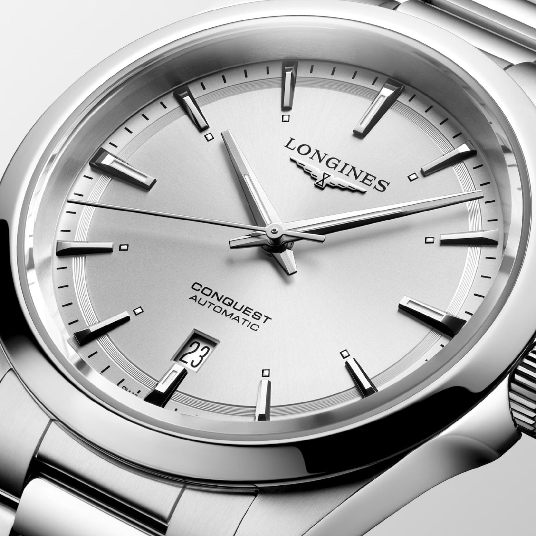 Close-up of the Longines Conquest Automatic 41mm Watch, showcasing its sleek metal band and minimalist silver dial. The wristwatch features a date window at the 3 o'clock position and is adorned with silver hour markers and hands, embodying both performance and elegance.