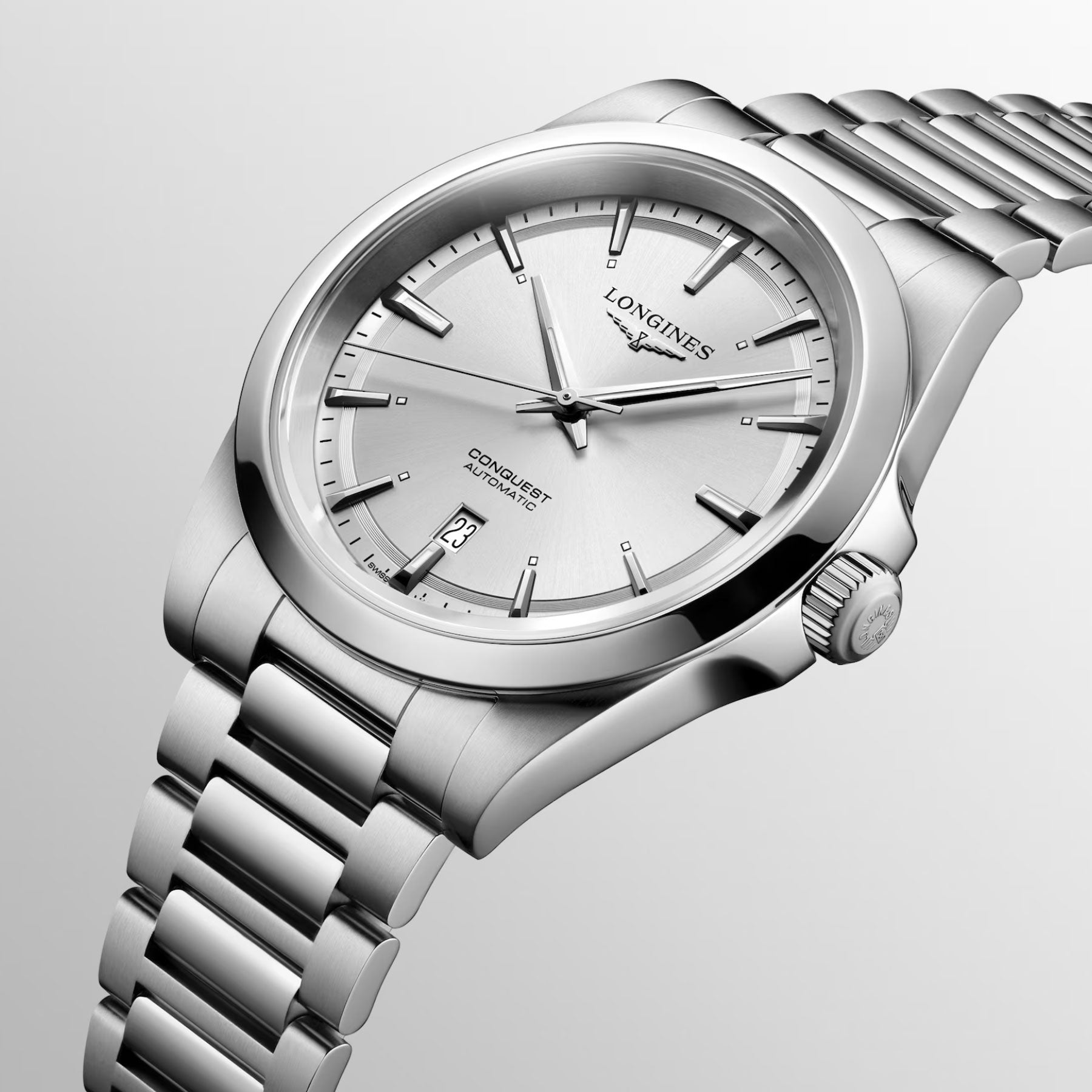 The Longines Conquest Automatic 41mm Watch features a silver wristwatch with a metallic band and a sleek, round face that displays the date. The brand name "Longines" is prominently visible on the dial. This watch exudes elegance with its minimalist design, showcasing simple hour markers and hands against a light gray background, which underscores its superior performance.