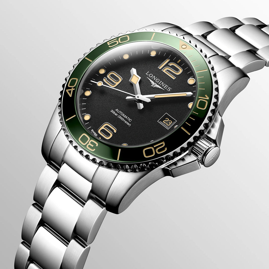 The Longines HydroConquest Automatic 41mm Watch, a distinguished piece from the renowned Swiss brand Longines, showcases a striking green bezel and black dial. This model from the HydroConquest collection includes silver hour markers, numerals at 6, 9, and 12, as well as a date window at 3 o'clock—all complemented by an elegantly polished link bracelet.