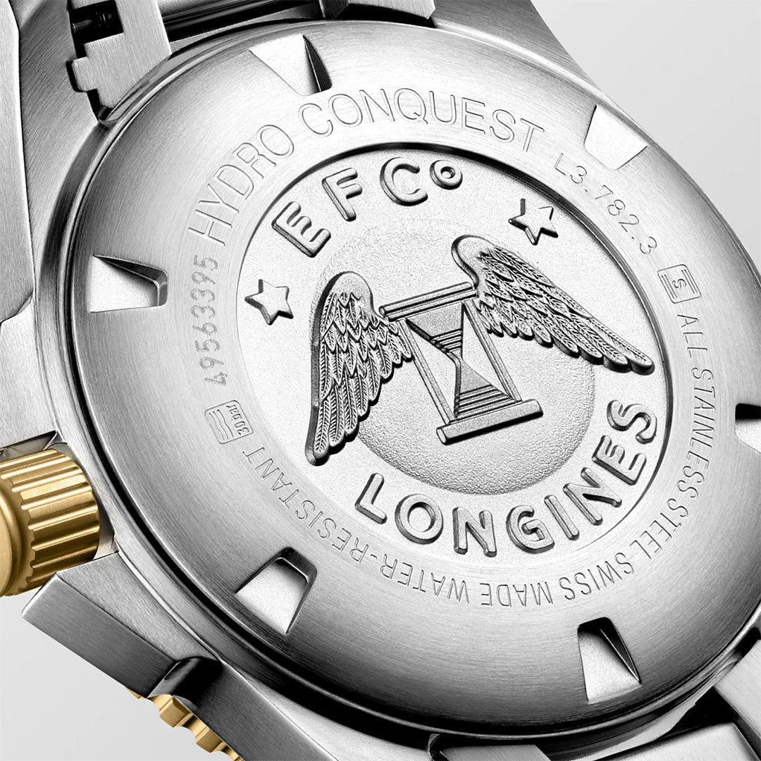 Close-up of the Longines Hydroconquest Automatic 43mm Watch’s silver, water-resistant back engraved with the Longines logo (wings and hourglass), plus “STAINLESS STEEL,” “SWISS MADE,” and a partially visible gold crown.