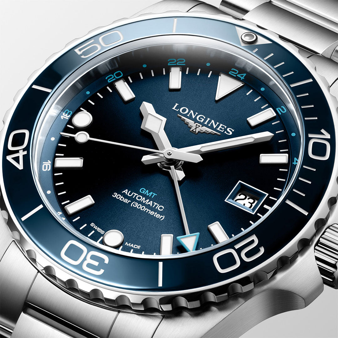 Close-up of a silver Longines HydroConquest Automatic 41mm Watch, showcasing a blue dial with prominent white numerals and hands. The stainless steel case includes a bezel with minute markers, and there's a date window positioned at 3 o'clock. The watch features a stainless steel bracelet.