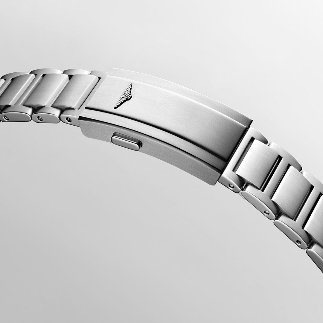 A close-up of the stainless steel bracelet from the Longines HydroConquest Automatic 41mm Watch, featuring a clasp adorned with a small wings logo. The bracelet's brushed metal finish and expertly interlocked links highlight an elegant and modern design against a light gray background.