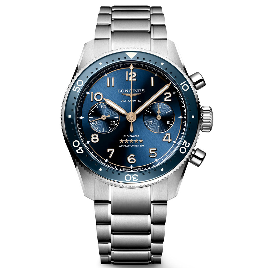 The Longines Spirit Flyback Automatic Chronograph 42mm Watch is a silver wristwatch with a metallic band and a blue round face. It features three subdials, white numerals, and the words "Flyback" and "Chronometer." This watch from the renowned brand with the winged hourglass logo has two pushers and a crown on the right side.