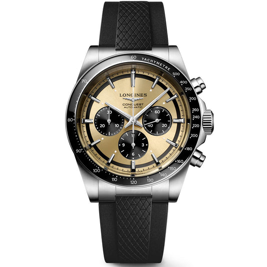 The Longines Conquest Chronograph Automatic 42mm Watch features a gold and black dial with three subdials, a tachymeter bezel, and a black textured rubber strap.