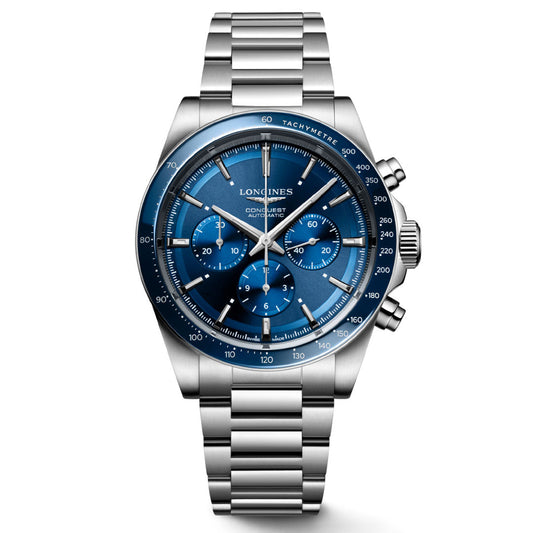 The Longines Conquest Automatic 42mm Watch radiates elegance with its stainless steel construction, silver metal strap, and captivating blue dial. It is equipped with three subdials for enhanced functionality, a tachymeter, and polished silver hands and markers, showcasing the Longines brand name prominently on the watch face.