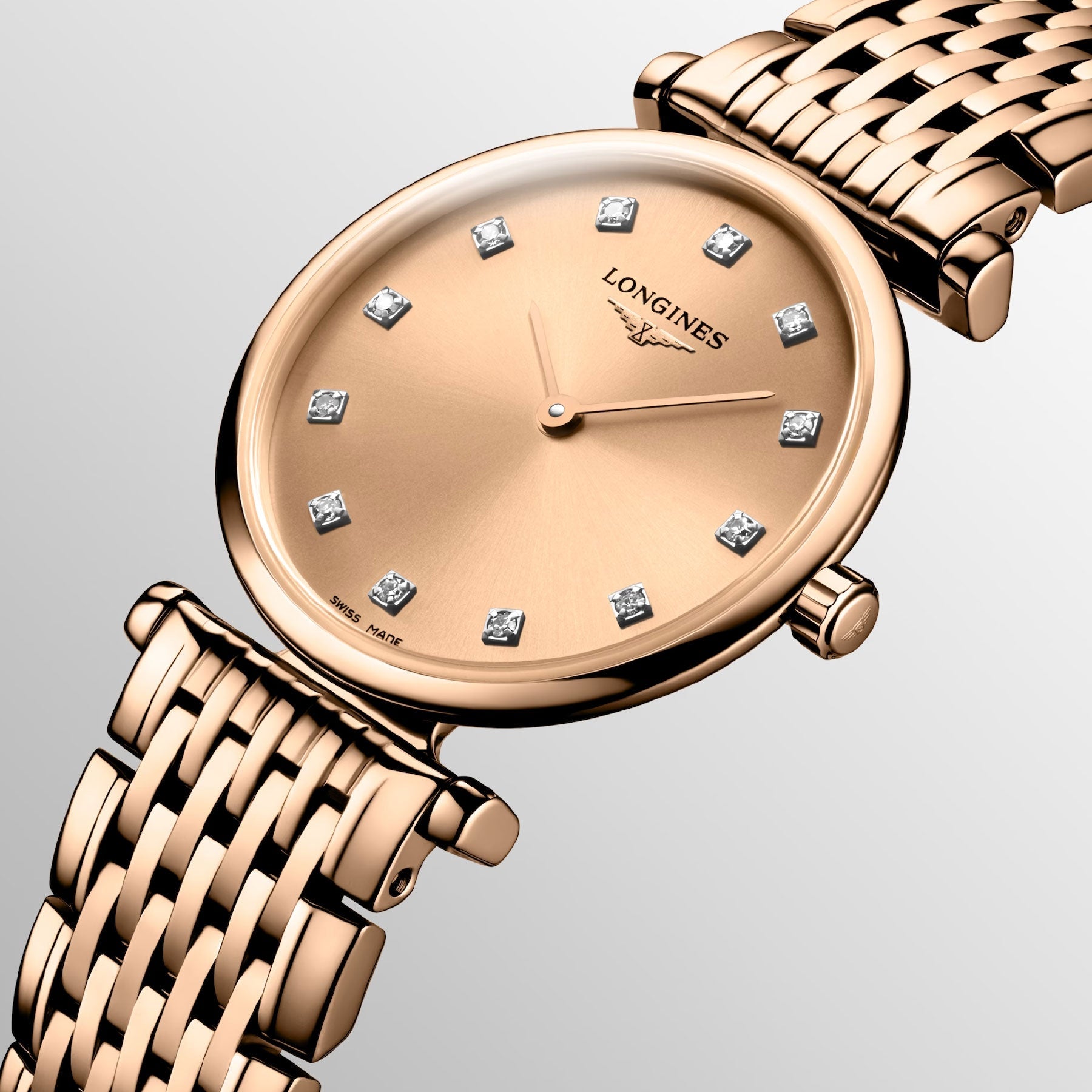 Explore the timeless sophistication of the Longines La Grande Classique De Longines Quartz 24mm Watch, adorned with a rose gold woven metal strap and a sleek round face. Diamond hour markers enhance its classic elegance, while the prestigious Longines brand name graces the dial against a light gradient background.