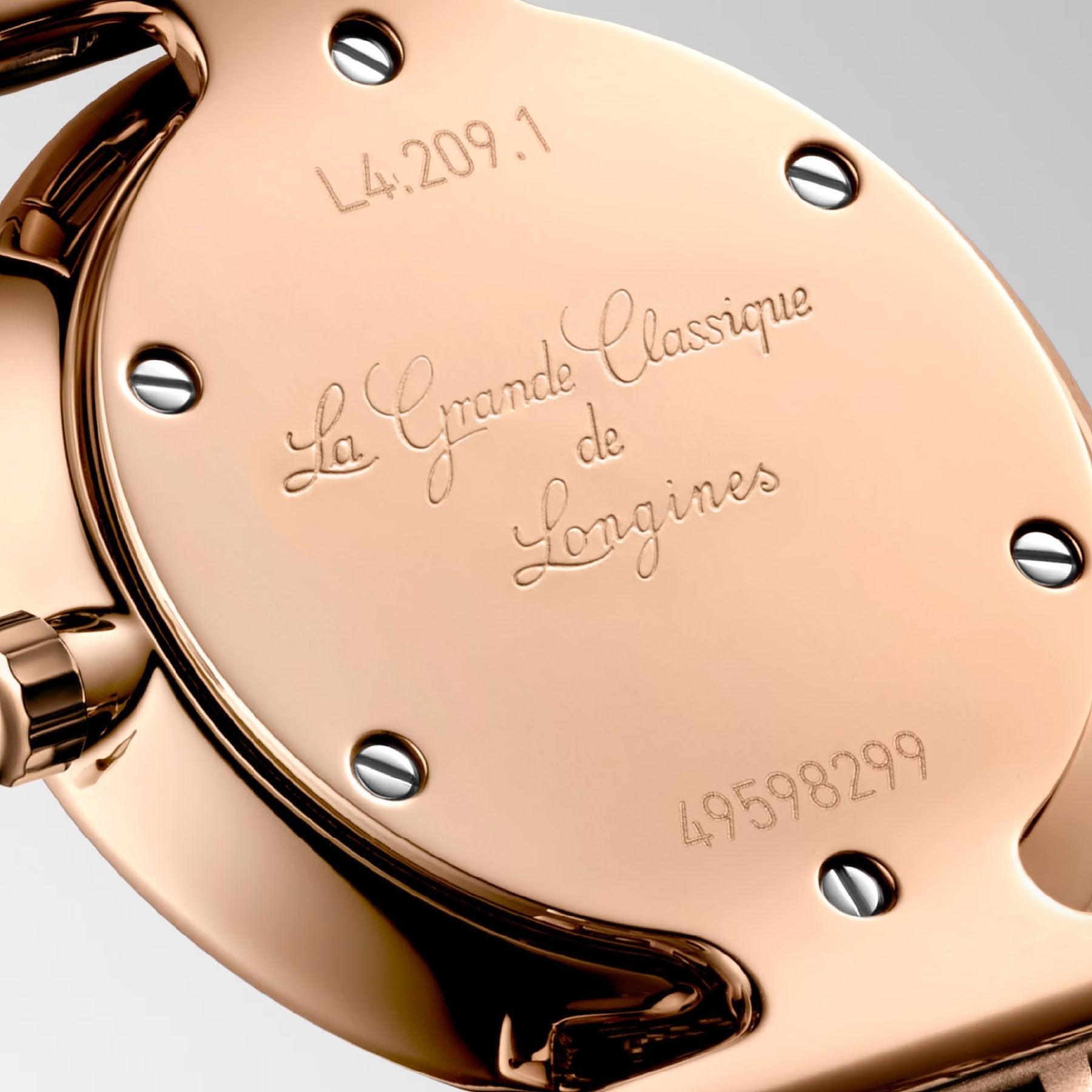 The polished gold backplate of the Longines La Grande Classique De Longines Quartz 24mm Watch highlights its classic elegance, with a model number of L4.209.1 and a serial number of 49598299. Four visible screws secure the plate, radiating timeless sophistication.