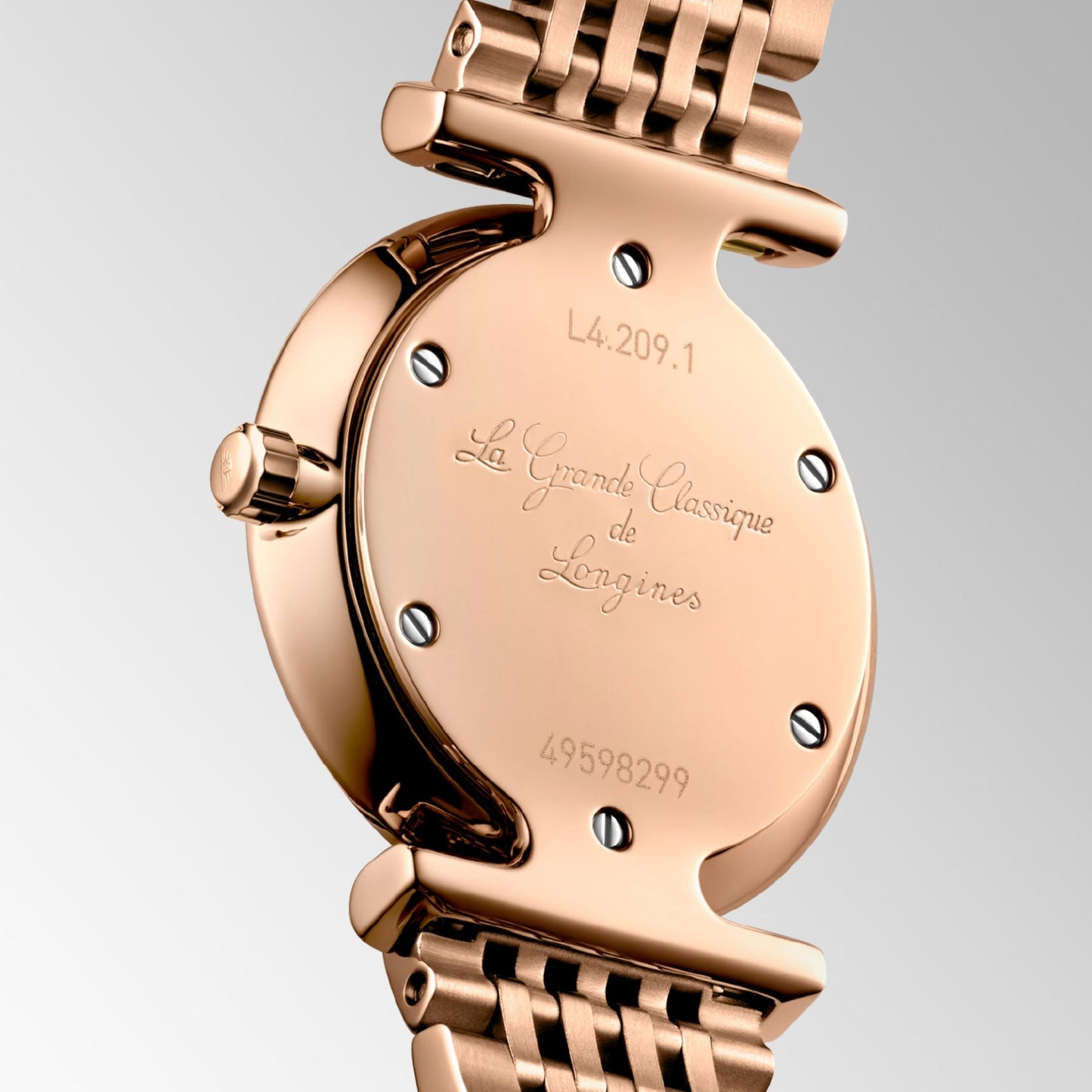 The image displays the back of a Longines La Grande Classique De Longines Quartz 24mm Watch in rose gold, highlighting the model number "L4.209.1" and the label "La Grande Classique de Longines." Its metal link bracelet embodies classic elegance, with the serial number "49598299" enhancing its timeless sophistication.