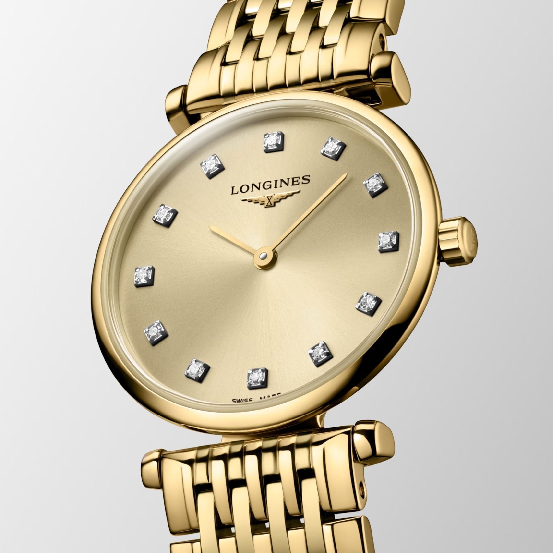 The Longines La Grande Classique De Longines Quartz 24mm Watch embodies timeless sophistication with its round face, diamond hour markers, and gold mesh bracelet. Its streamlined hands against a gold background epitomize classic elegance, offering a truly luxurious and refined design.