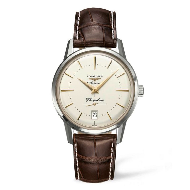 The Longines Flagship Heritage Automatic 38.5mm watch features a white dial, a brown leather strap with intricate stitching for an elegant finish, and a silver casing. This vintage-inspired timepiece from Longines includes hour markers, a date window, and the inscriptions "Automatic" and "Flagship.