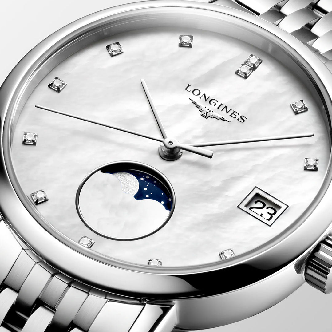 Close-up of the Longines Elegant Collection Moonphase Quartz 30mm watch featuring a silver case, white dial with diamond hour markers, moonphase at 6 o'clock, date window at 3 o'clock, metal bracelet, and sapphire crystal.