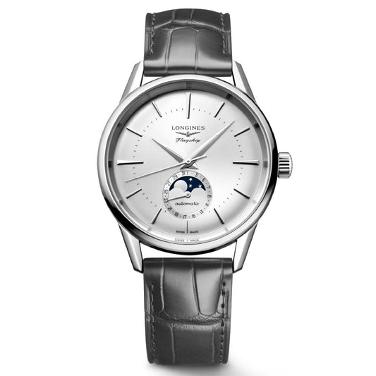 A Longines Flagship Heritage Automatic 38.5mm Watch, featuring a silvered sunray dial, gray alligator leather strap, and moon phase complication. The round face showcases sleek hour markers alongside the Longines logo, highlighting an elegant blend of functionality and style.