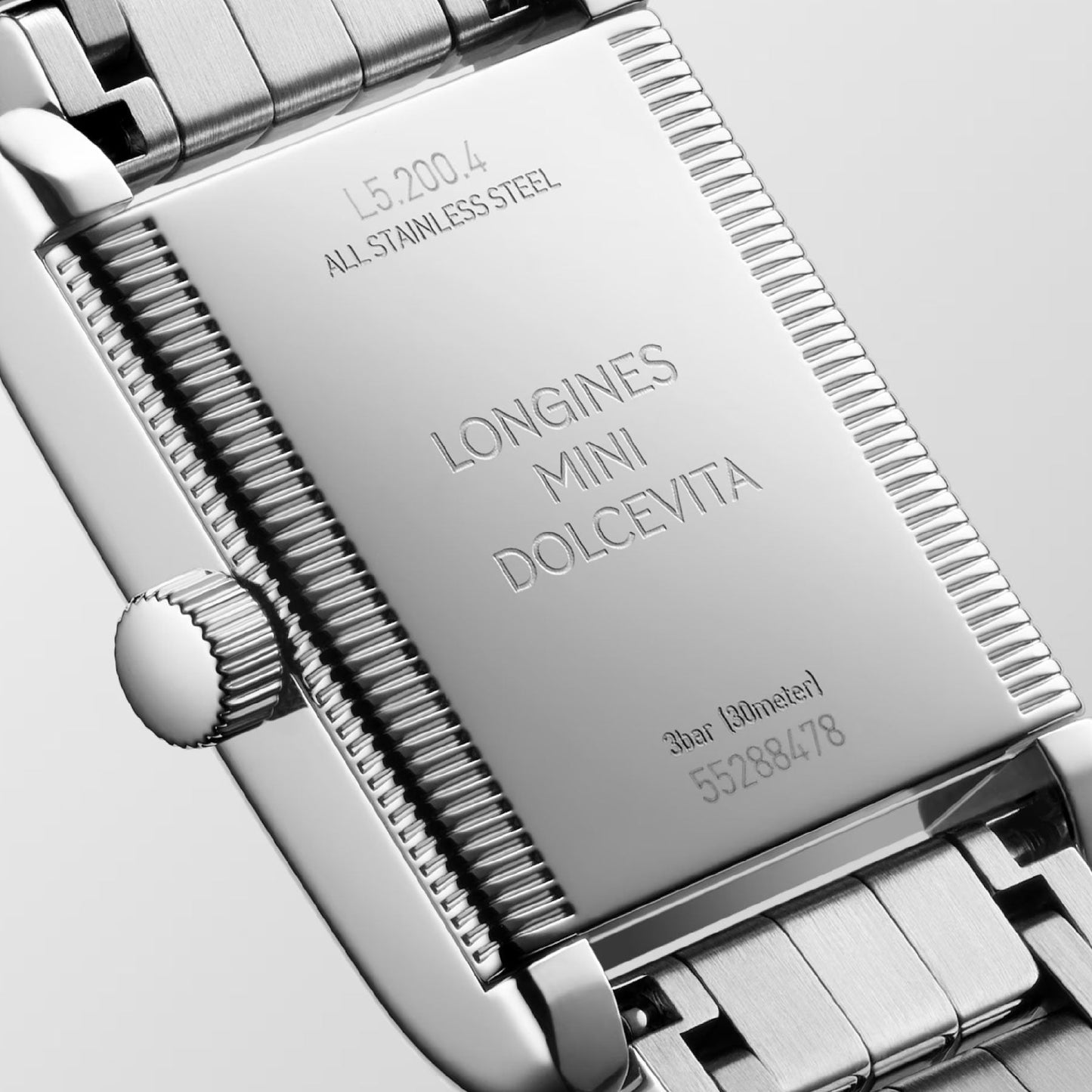 The image captures the back of a Longines Mini Dolcevita Quartz 21.5 x 29mm watch, highlighting its stainless steel case with engraved model details such as "L5.120.4" and "ALL STAINLESS STEEL," along with water resistance rated at "3 bar (30 meters)." This sophisticated timepiece from Longines features a dependable quartz movement.