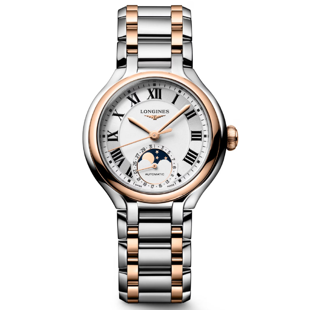 The Longines Primaluna Moonphase Automatic 34mm is a luxury women’s watch featuring a silver and rose gold band, white dial, black Roman numerals, and a moon phase subdial above 6 o’clock.