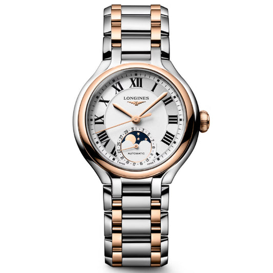 The Longines Primaluna Moonphase Automatic 34mm is a luxury women’s watch featuring a silver and rose gold band, white dial, black Roman numerals, and a moon phase subdial above 6 o’clock.