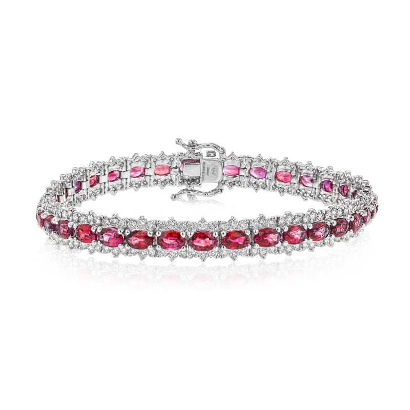 The Simon G. 18K White Gold Diamond with Ruby Bracelet features twin rows of oval-shaped rubies, beautifully crafted with delicate, shimmering accents interspersed between each gem. The sophisticated clasp adds to the bracelet's refined elegance.