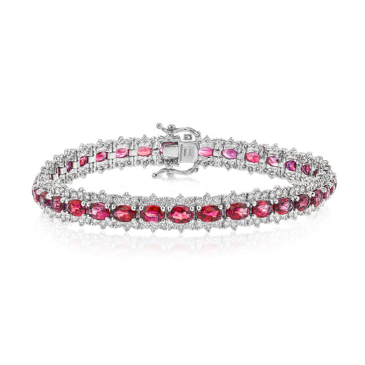 The Simon G. 18K White Gold Diamond with Ruby Bracelet features twin rows of oval-shaped rubies, beautifully crafted with delicate, shimmering accents interspersed between each gem. The sophisticated clasp adds to the bracelet's refined elegance.