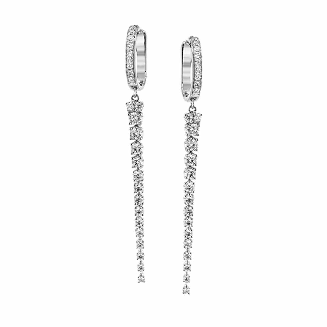 Presenting the Simon G. 18K White Gold Diamond Earrings, crafted by the renowned brand Simon G. These elegant earrings showcase a refined hoop design with a long, narrow line of dazzling diamonds. Their allure is further enhanced by exquisite 18 Karat white gold craftsmanship, providing a sophisticated and stylish appearance.