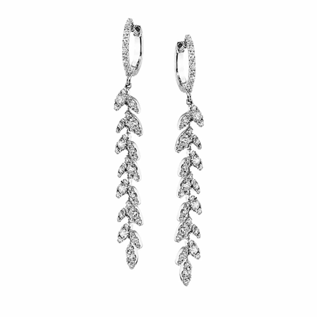 Simon G's exquisite 18K white gold drop earrings, featuring a leaf motif adorned with shimmering diamonds, dangle elegantly in a vertical design.