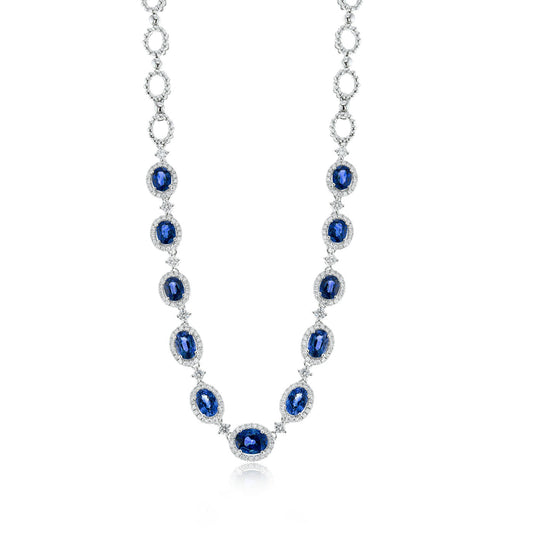 Introducing the Simon G. 18K White Gold Sapphire with Diamond Necklace: a breathtaking piece featuring oval blue sapphires, each beautifully surrounded by small sparkling diamonds. The gems are artfully set in 18kt white gold and evenly distributed along the interconnected chain links, offering a luxurious and sophisticated allure.