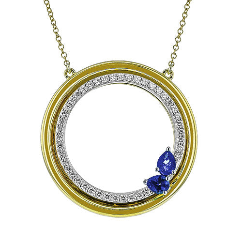 The Simon G. 18K White and Yellow Gold Diamond and Sapphire Necklace Pendant features a circle of round diamonds with a blue sapphire accent, all on a delicate gold chain.