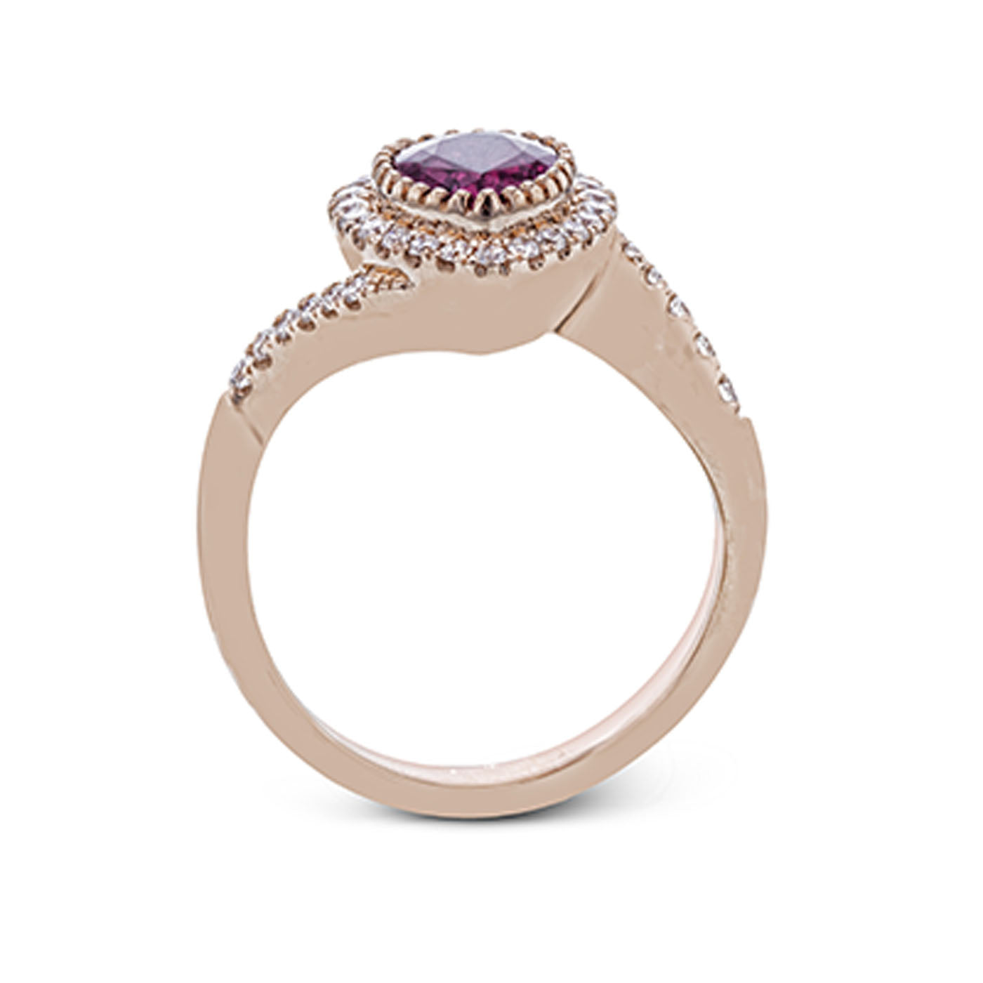 Introducing the Simon G. 18K Rose Gold Pear Shape Ruby with Diamond Fashion Ring, a captivating piece that showcases a pear-shaped ruby encircled by sparkling white diamonds, complemented by additional diamonds elegantly set along the band.