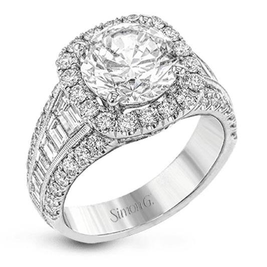 Introducing the Simon G 18K White Gold Baguette Halo Diamond Ring, a stunning engagement ring showcasing a prominent round diamond at its heart, encircled by a halo of smaller diamonds. The intricately designed band features additional diamonds, including elegant baguette cut diamonds for an extra touch of sophistication, all crafted by the renowned brand Simon G.