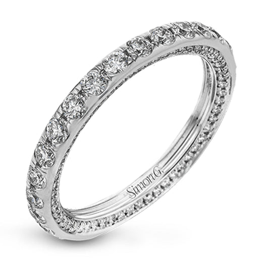 The Simon G. 18K White Gold Diamond Anniversary Ring features a captivating design with round white diamonds totaling 1.52 ctw, elegantly set around the band. The interior of the ring is intricately engraved, all presented against a pristine white backdrop.