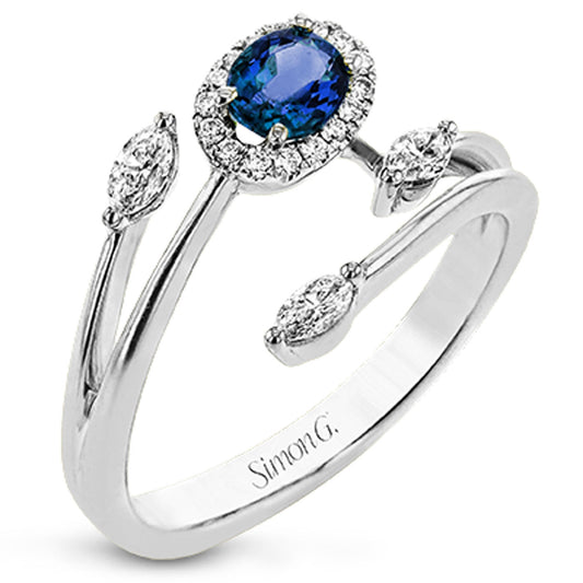 The Simon G. 18K White Gold Sapphire with Diamond Fashion Ring highlights a central oval sapphire encircled by delicate diamonds, flanked by two marquise diamonds on each side. Its expertly crafted split band embodies elegance and timeless beauty.