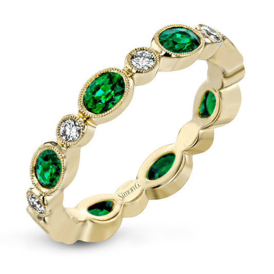 The Simon G. 18K Yellow Gold with Diamond and Emerald Ring from Simon G features alternating oval emeralds and white diamonds set in bezel settings, showcasing an elegant and intricate design with a polished finish.