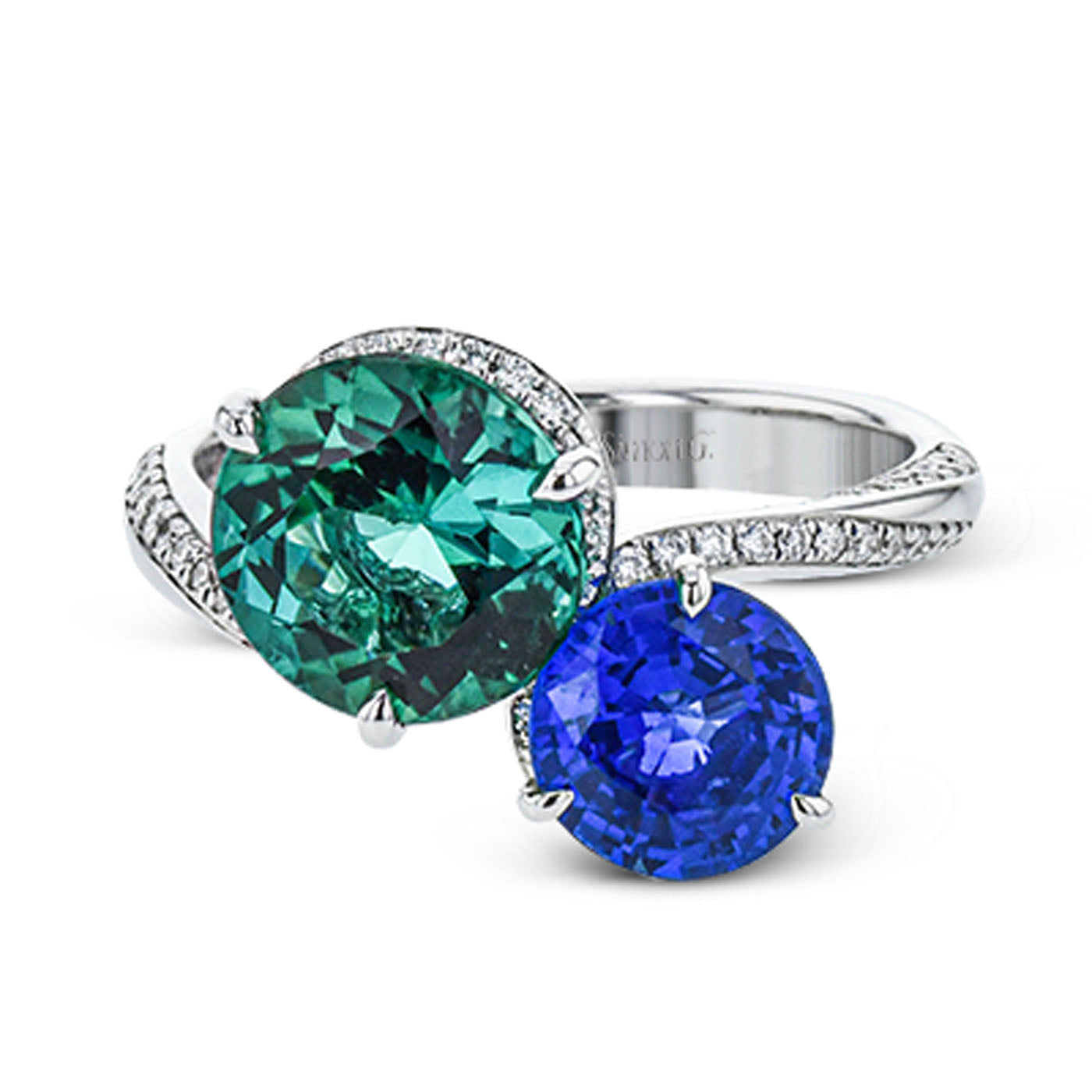 The Simon G. 18K White Gold Tourmaline and Sapphire with Diamond Ring features a vibrant green tourmaline and a deep blue sapphire, with the band embellished in small diamonds, enhancing the elegance and contrast of these colorful stones.