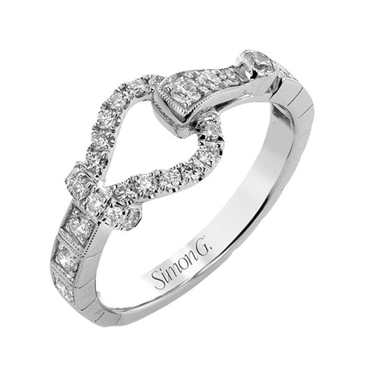 A gorgeous heart-shaped ring in 18K white gold glistens with small round diamonds, showcasing the "Simon G" name on the inside band.