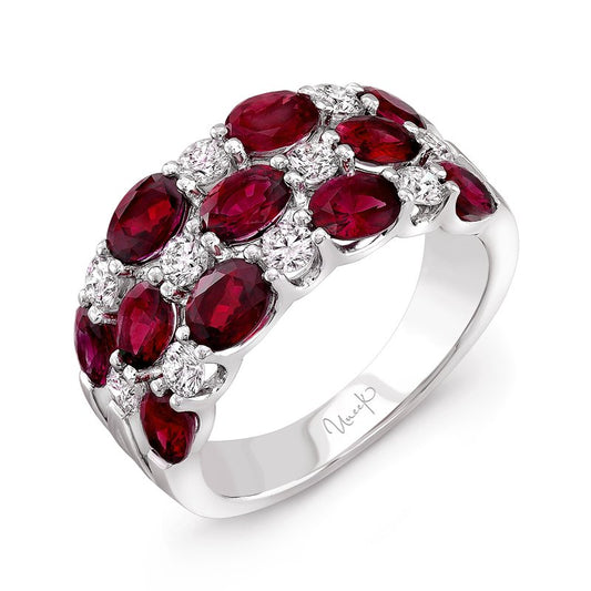 The Uneek 18K White Gold with Ruby and Diamond Ring is an exquisite piece, featuring a stunning cluster pattern of oval rubies and small round diamonds.