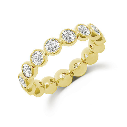 Introducing the Uneek Stackable 18K Yellow Gold Diamond Fashion Ring, featuring an exquisite design with 2.75TWT round diamonds arranged in a circular pattern along the band. This beautiful piece by Uneek elegantly alternates between raised diamond settings and smooth gold surfaces, offering a textured and sophisticated look perfect for stacking.