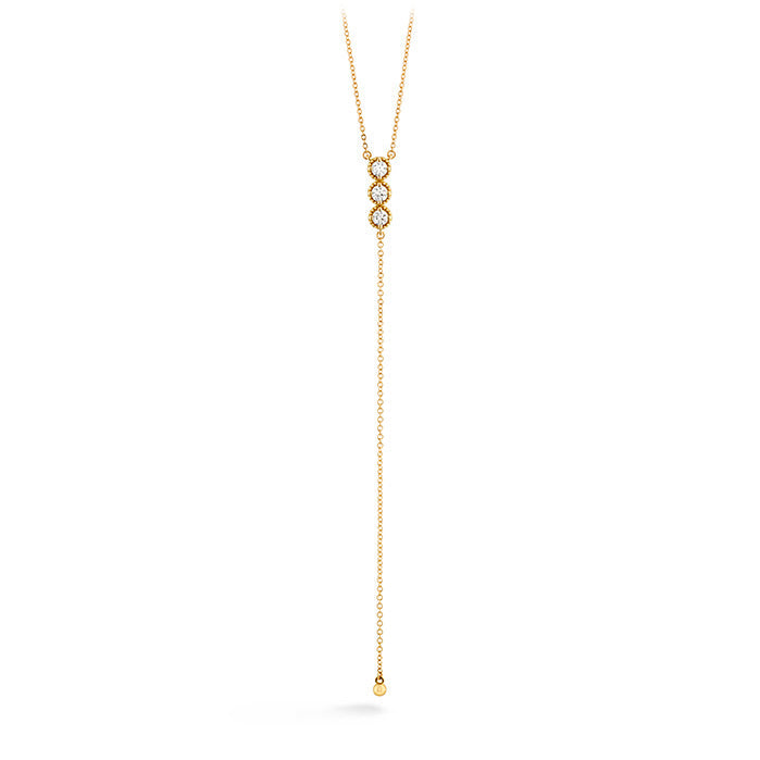 Introducing the Hearts On Fire Liliana Milgrain Lariat Necklace by Hearts on Fire, a stunning 18 Karat Yellow Gold creation. This exquisite piece showcases a delicate lariat chain with two interlocking loops embellished with small diamonds. Completing the elegant design, a long, single chain extends downward and features a small gold bead at its end.