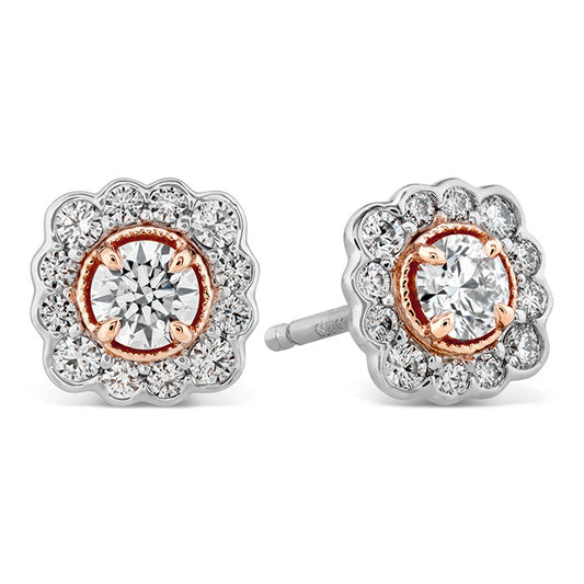 A close-up of the Hearts On Fire Liliana Flower Stud Earrings reveals an elegant design, showcasing a central round diamond encircled by smaller diamonds in a scalloped floral pattern. The rose gold accents enhance the sparkle of the piece, exemplifying the craftsmanship of Hearts on Fire.