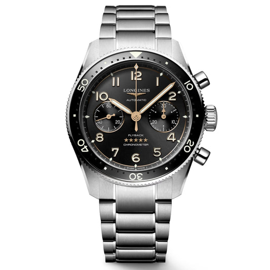 The Longines Spirit Flyback Automatic Chronograph 42mm Watch features a silver wristwatch design with a black dial, highlighted by Arabic numerals, two subdials, and gold-tone hands and markers. It includes a rotating bezel and is paired with a stainless steel bracelet that complements the iconic Longines style while showcasing the winged hourglass brand emblem, celebrating legendary pioneers.