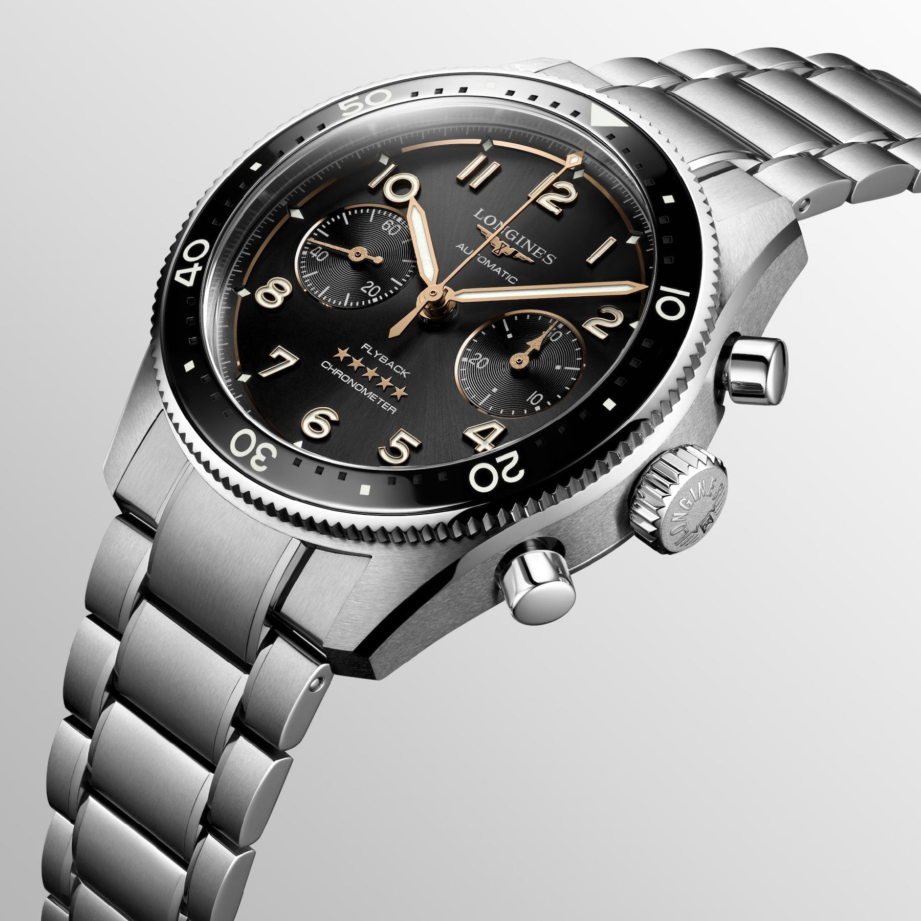 Introducing the Longines Spirit Flyback Automatic Chronograph 42mm Watch, a luxurious stainless steel timepiece featuring a black bezel and dial, embellished with three subdials and striking gold hands. This exquisite watch from Longines encapsulates the timeless elegance of legendary pioneers and is elegantly showcased on a light gray background.