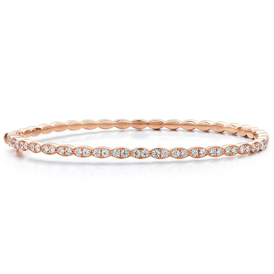 Introducing the Hearts On Fire Lorelei Floral Bangle Bracelet, an exquisite 18 Karat Rose Gold creation from Hearts on Fire. This delicate piece features small embedded diamonds forming a continuous loop, making it perfect for achieving an elegant and understated look.