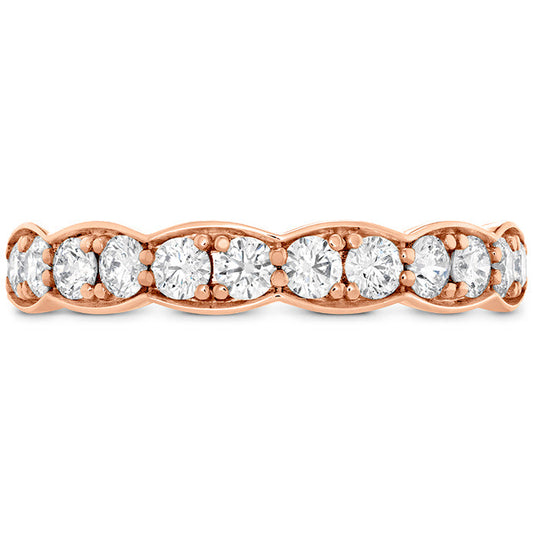 The Hearts On Fire Lorelei Floral 18K Rose Gold Round Brilliant Diamond Anniversary Ring by Hearts on Fire showcases a row of round, sparkling diamonds beautifully set along the band. The subtle floral pattern intricately arranges the diamonds, creating a luxurious and exquisite appearance.